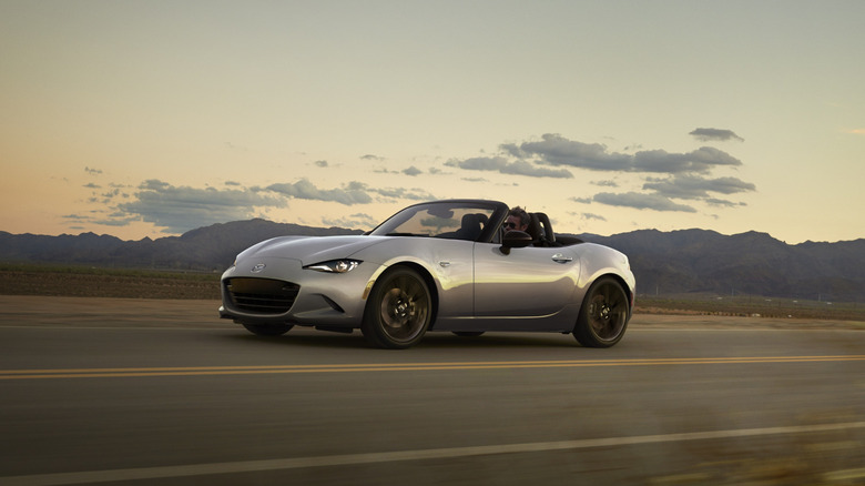 A silver Mazda MX-5 Miata driving