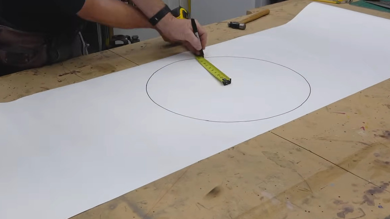 Man making circle using tape measure