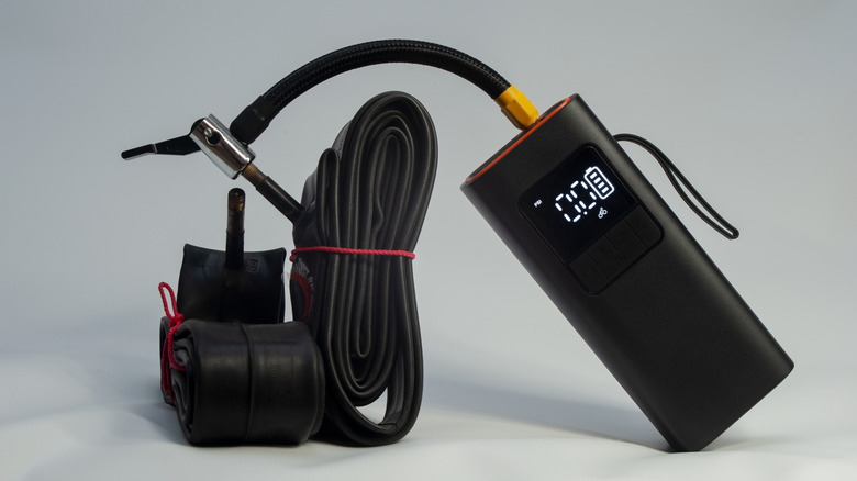 A portable electric tire inflator with no visible brand.