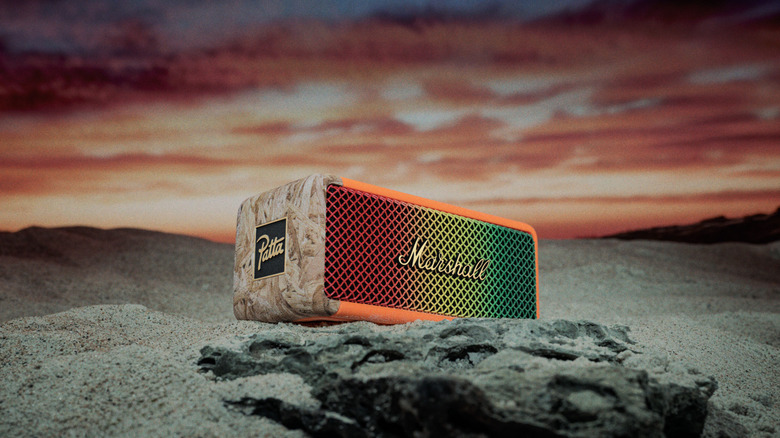 Limited edition Emberton II Marshall speaker with multi-color design in a natural setting with the sunset behind