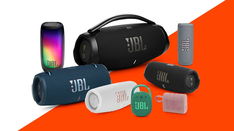 Assortment of JBL speakers on a white and orange background