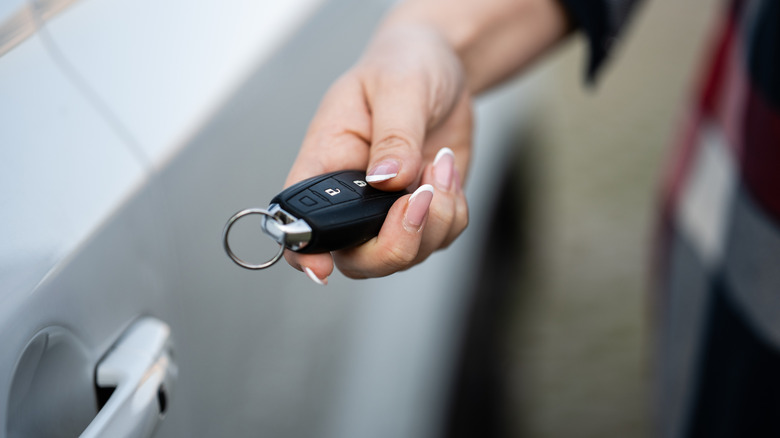 A car owner operating a key fob