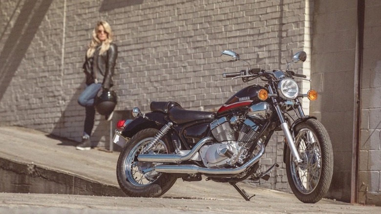 Yamaha V Star 250 parked with a rider standing behind it