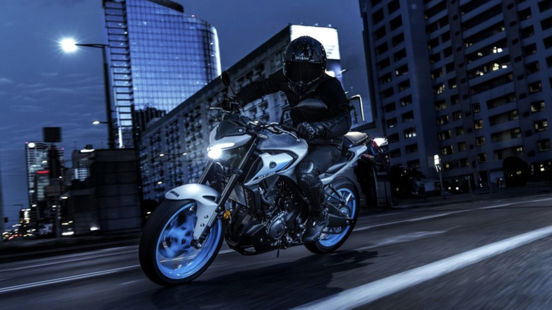 Yamaha MT-03 being driven through the city at night
