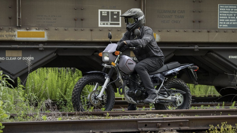 Yamaha TW200 riding along railroad tracks