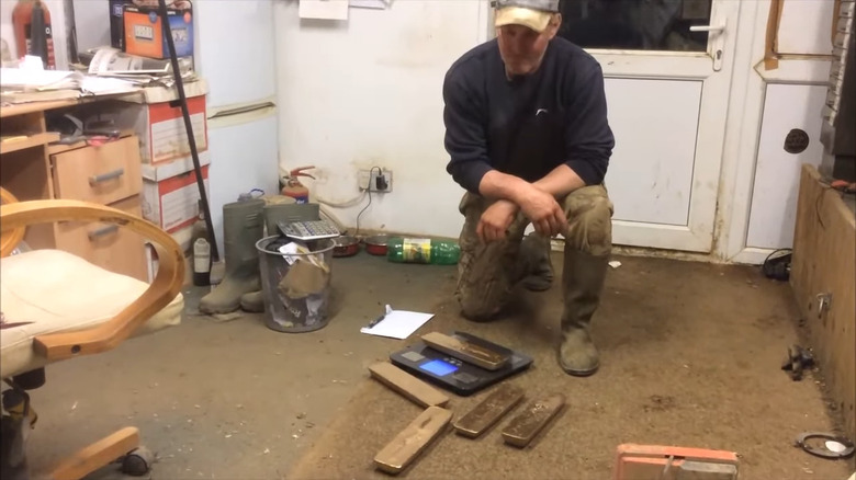 Todd Chamberlain weighing gold bars that he found inside the tank