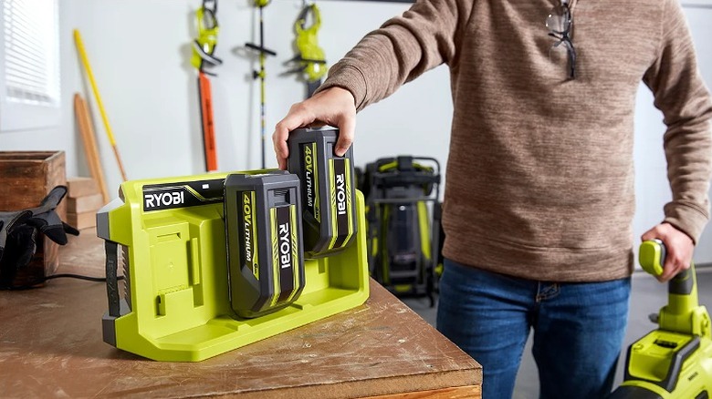 Two Ryobi batteries mounted onto a fast charger.