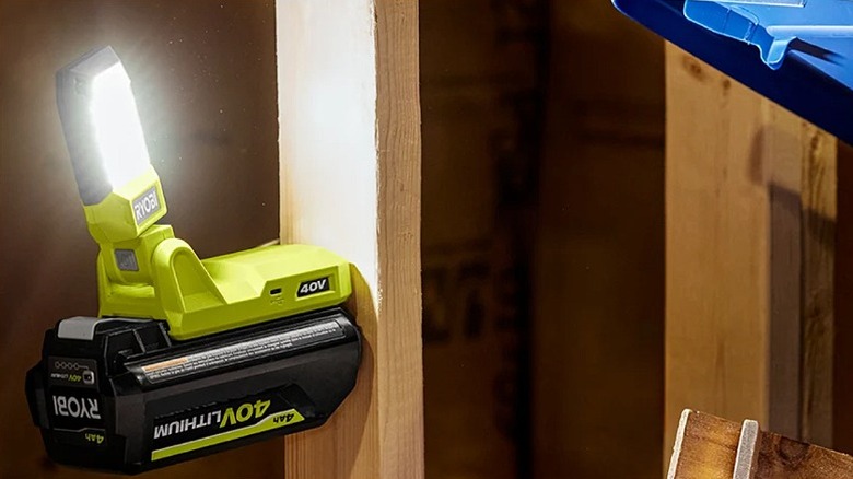 Ryobi work light mounted on a wooden bar.
