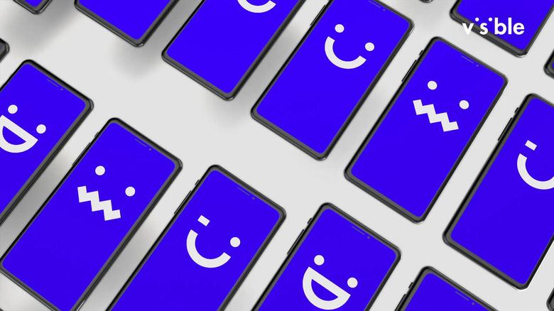 Phones with blue screens and emoticon faces