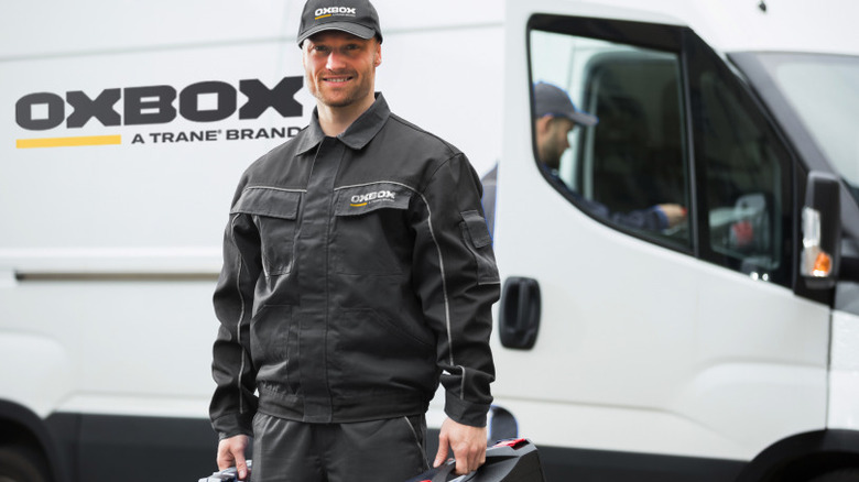 Oxbox contractor standing in front of a company van.