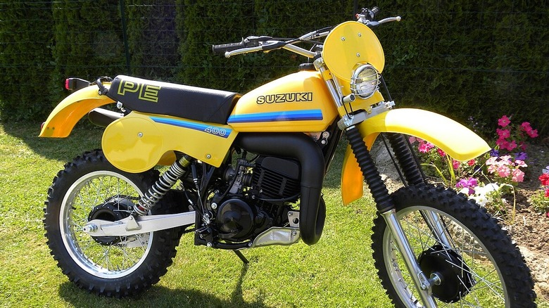Yellow Suzuki PE dirtbike in yard
