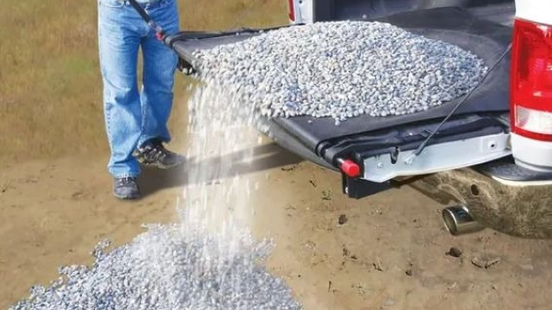 rocks pouring out of the back of a pickup truck