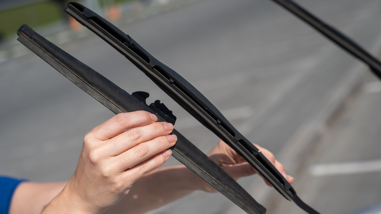 A person changing their wiper blades