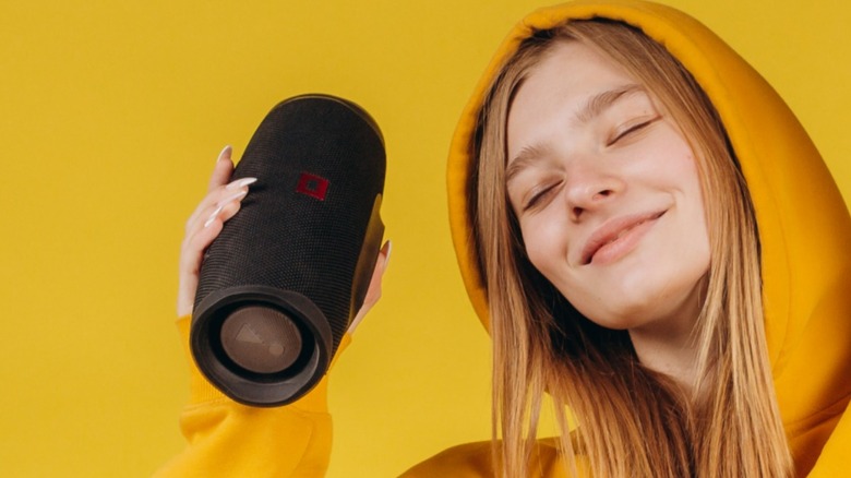 Person holding Bluetooth speaker 