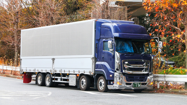 Isuzu Giga semi-truck seen from right front in a parking lot
