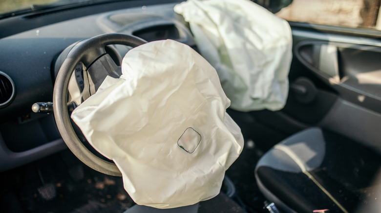 A pair of deployed airbags in a car.