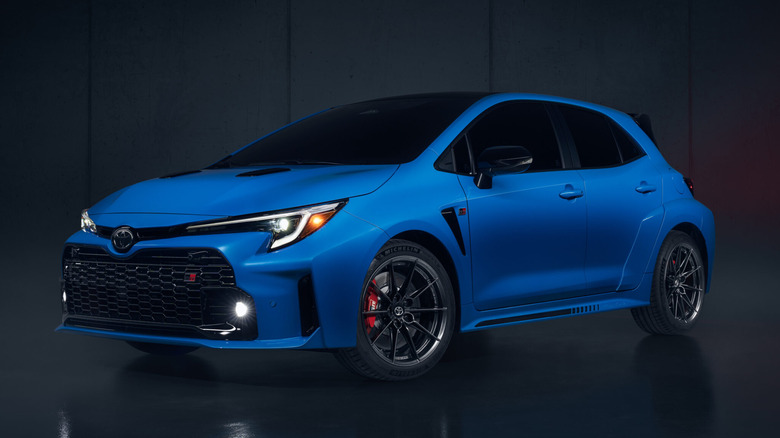 Blue Toyota GR Corolla in a dark room
