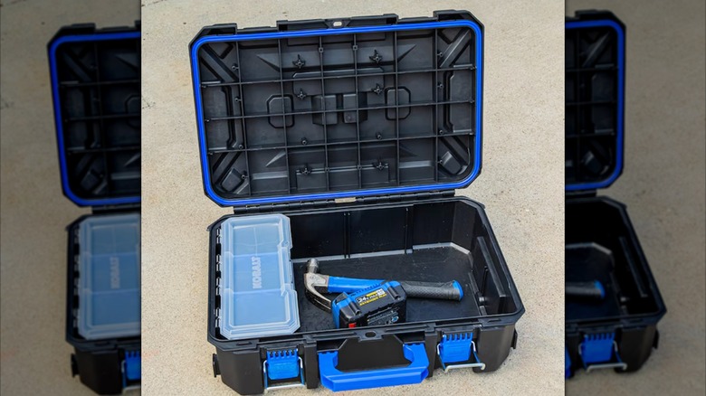 Open Kobalt small toolbox with a bin, hammer, and 24V battery inside