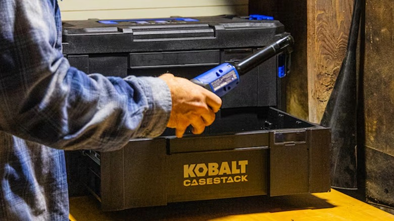 Person retrieving a tool from a Kobalt CaseStack two-drawer toolbox