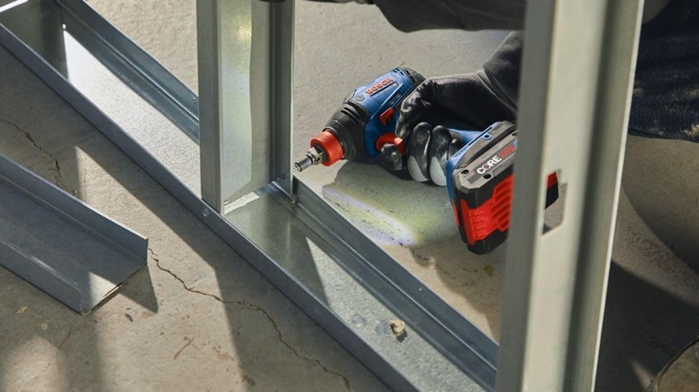 Fastening together a metal frame with Bosch driver/wrench.