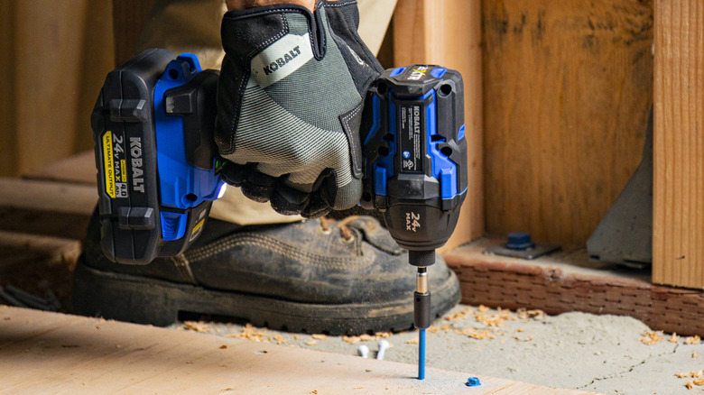 A person installing screws with a Kobalt XTR Max 24V Impact Driver.
