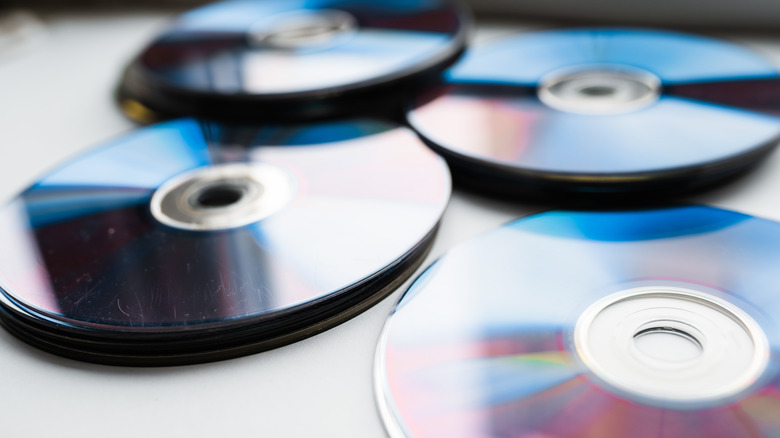 CDs arranged messily on a table