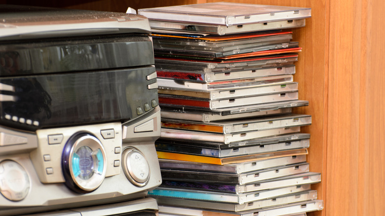 A stack of CDs next to a mini Hi-Fi