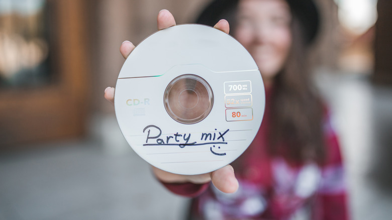 Person holding up a CD with writing on the label
