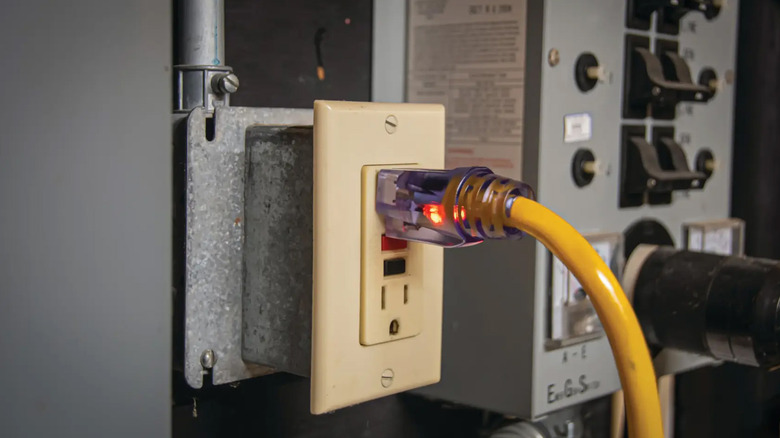 A DeWalt extension cable plugged into an outlet