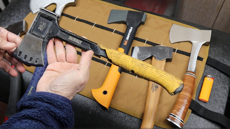 A man holding a DeWalt steel camper's axe