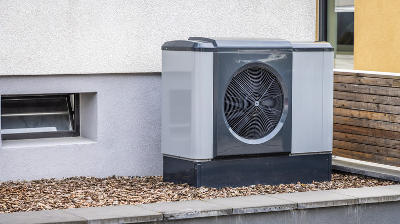 Heat pump unit outside a building in a bed of mulch