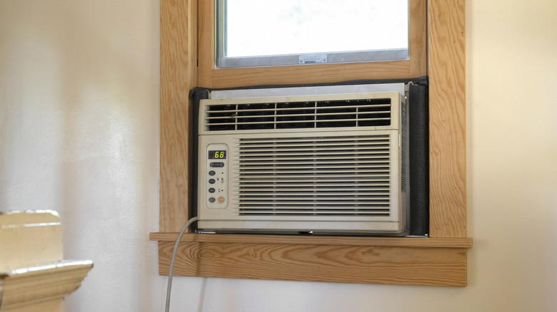 An air conditioner unit sitting in a window