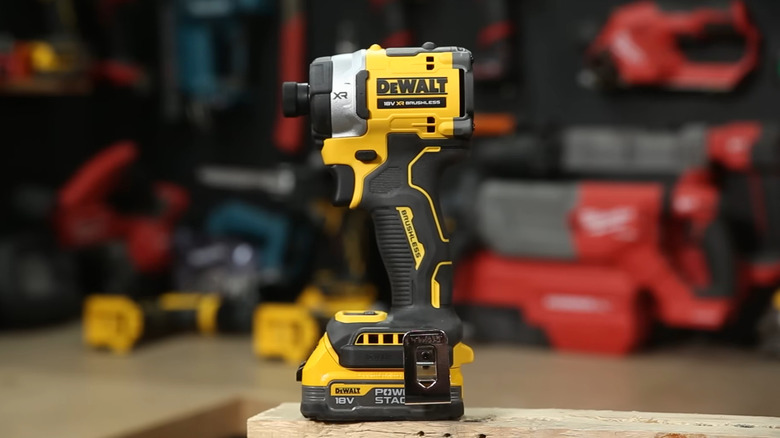 The DEWALT 20-Volts MAX XR Lithium-Ion Impact Driver standing on a workbench, other tools in the background