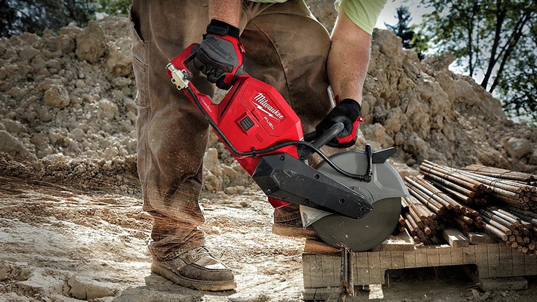 A worker using the Milwaukee M18 Fuel One-Key Circular Saw to trim rebar on a pallet