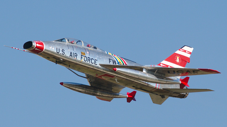F-100 jet seen from below left flying at Airventure air show in 2015