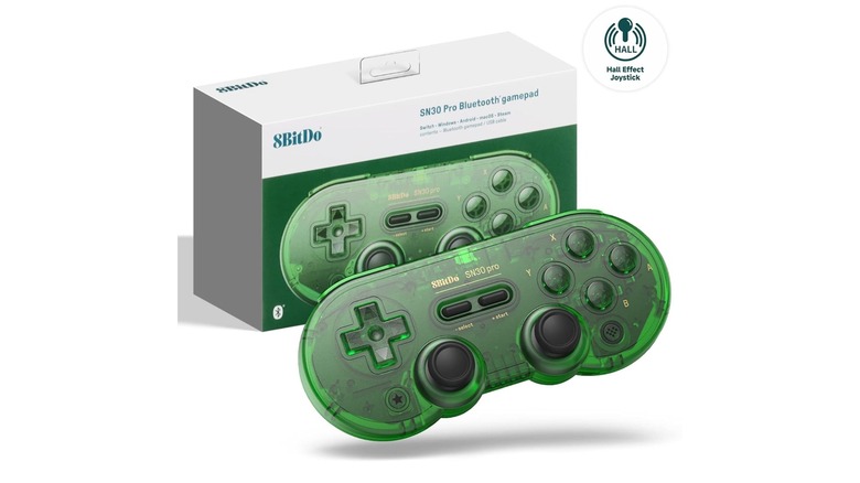 Green video game controller next to its packaging