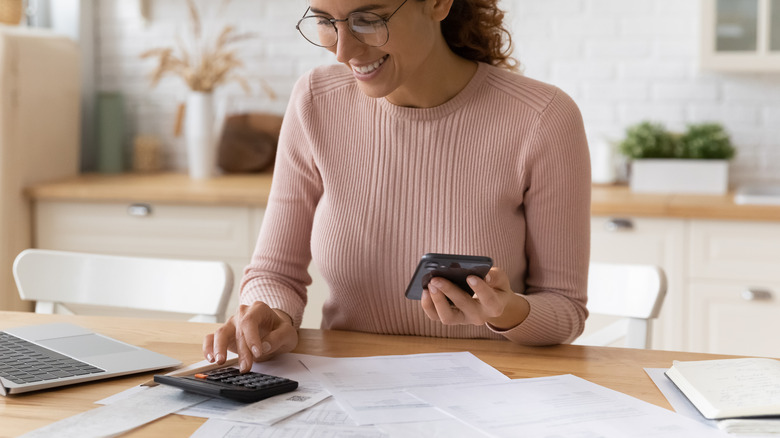 woman filing taxes with calculator