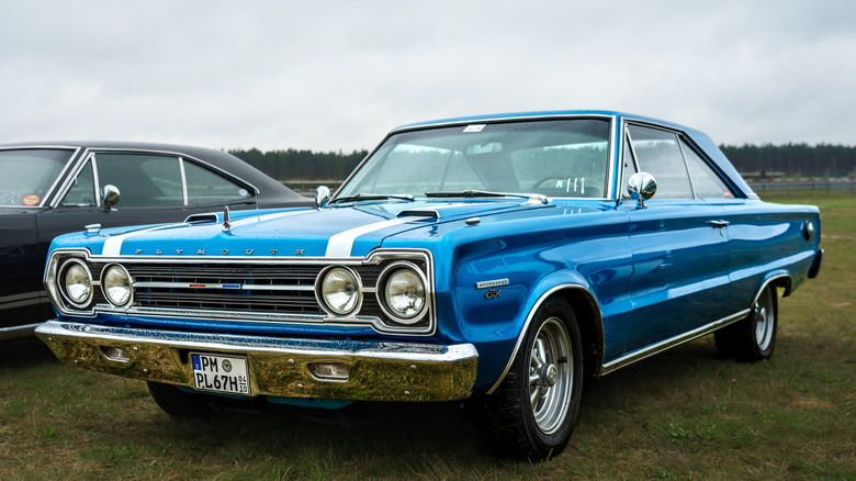 1967 Plymouth GTX parked on grass, front-left 3/4 view
