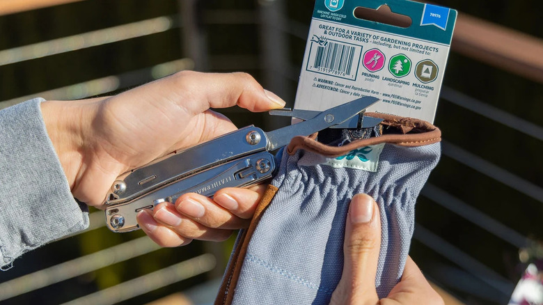 Leatherman Wingman being used to cut through plastic