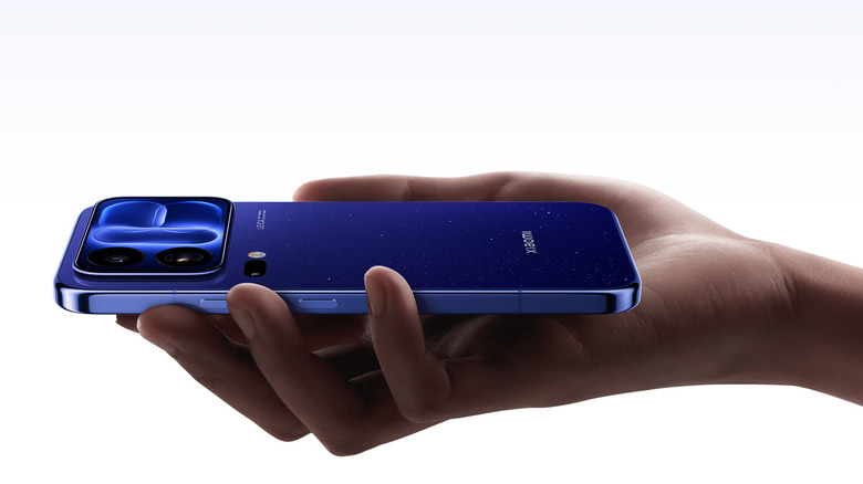 Hand holding a blue Xiaomi phone