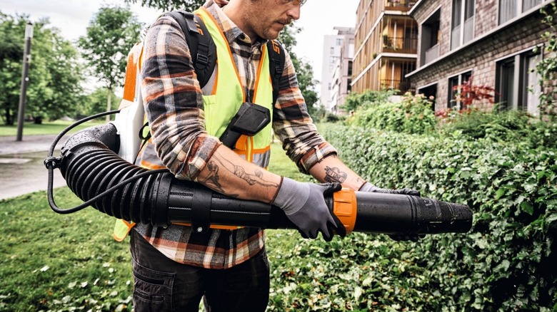 Professional adjusting the nozzle of a Stihl BRA 280 blower