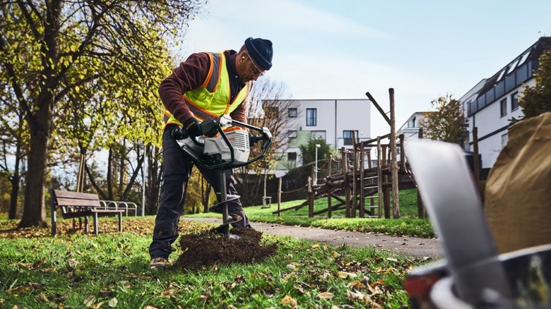 Stihl BTA 140 earth auger digging a hole