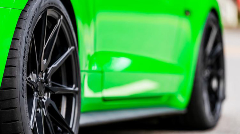 A green sports car with a Continental ExtremeContact Sport 02 tire