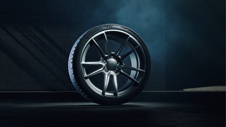 The Continental SportContact 7 on a tire mount in a dark room