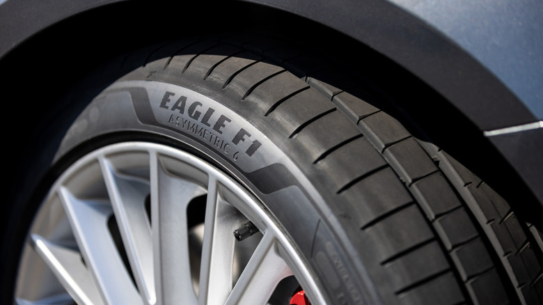 A Goodyear Eagle F1 Asymmetric 6 tire close up on a blue car
