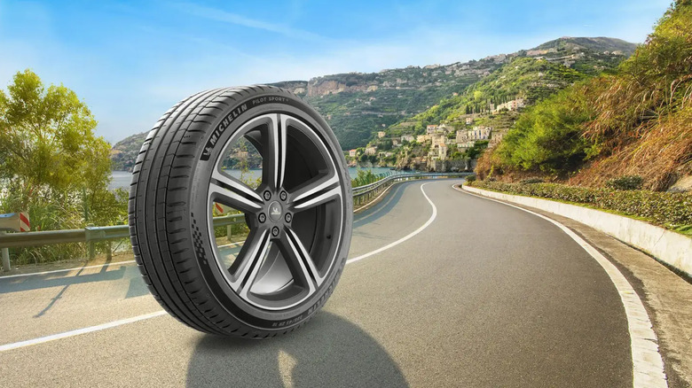 A Michelin Pilot Sport 5 enlarged on a road near a seaside town