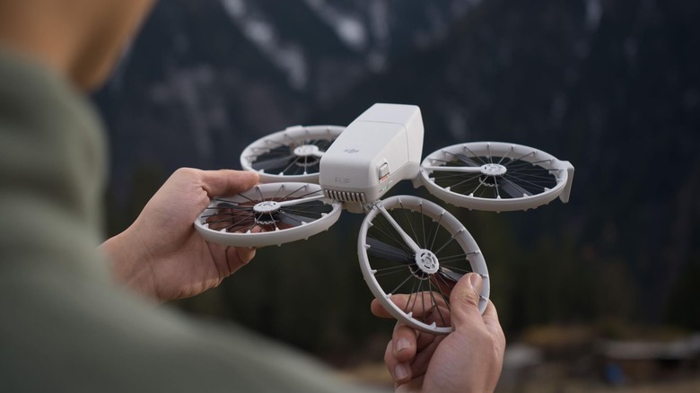 A person unfolding the DJI Flip