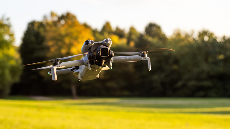 DJI Mini 5 Pro flying in a field