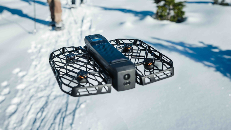 HoverAir X1 Pro following someone on a snow mountain