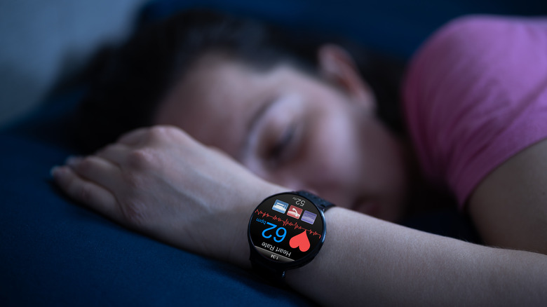 Smartwatch heart rate monitor watch on sleeping woman